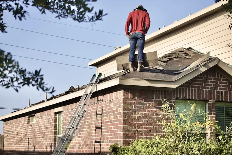 Professional roofer working on a residential roof in Heart of Texas